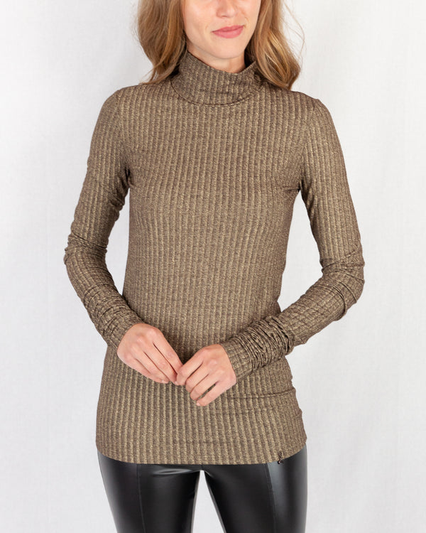 Gold Lurex Ribbed Turtle Neck. Slim Fitting With Extra Long Slim Sleeve. Below Hip Length With A Fly Charm Logo On Hem.