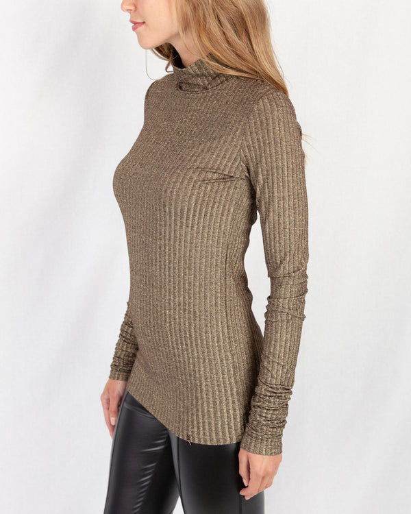 Gold Lurex Ribbed Turtle Neck. Slim Fitting With Extra Long Slim Sleeve. Below Hip Length With A Fly Charm Logo On Hem.